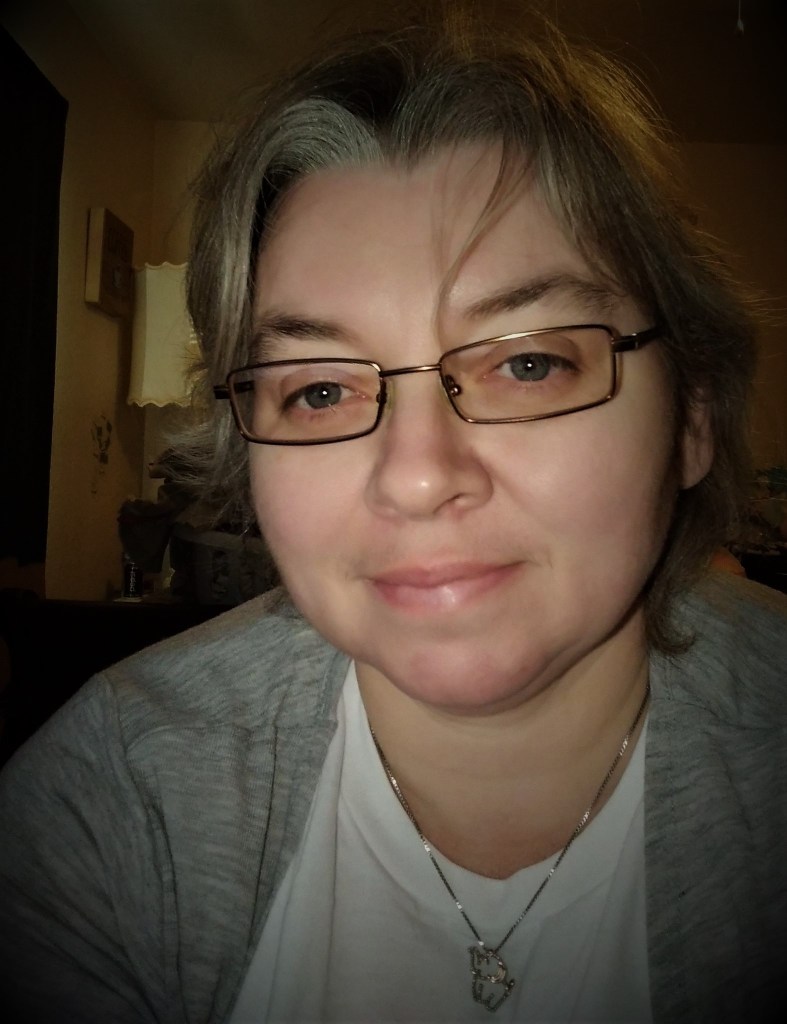 Picture of author Daphne Self. She wears glasses and faces the camera.