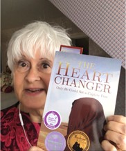Jarm Del Boccio holding a copy of The Heart Changer.